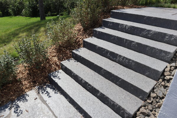 Grey natural stone steps going up entryway